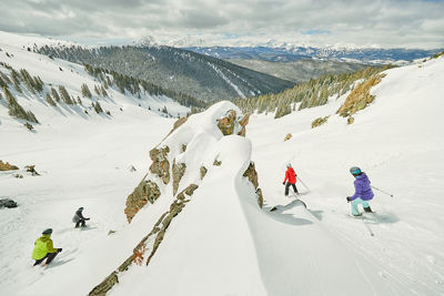 Group riding rocky zone while cat skiing at Keystone Resort