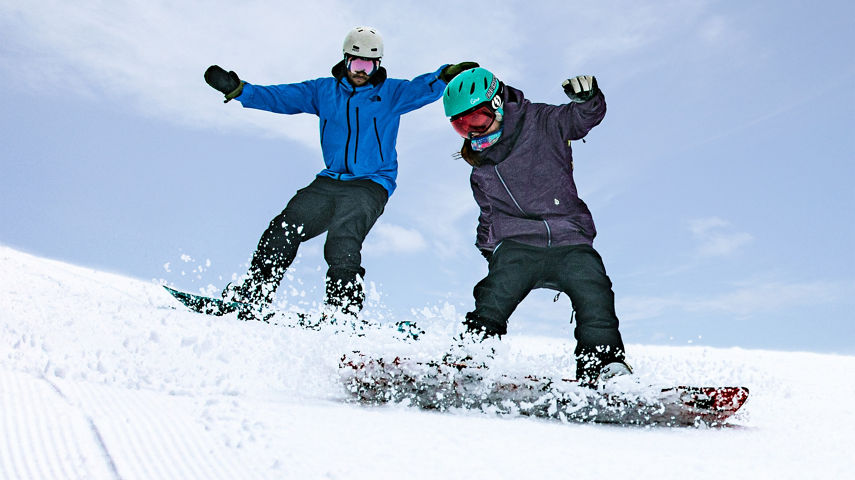 Two Snowboarders Turn on Corduroy Run at Hunter Mountain