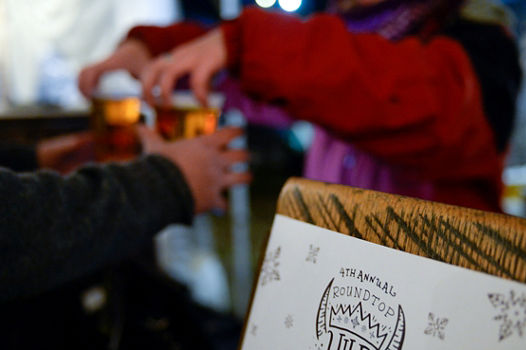 Bartender Hands Beer to Guest at Ullr Fest Event at Roundtop