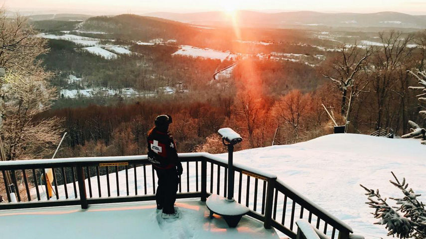 Ski Patroller Overlooks Mountain at the Top of Gunbarrel during Sunrise at Roundtop