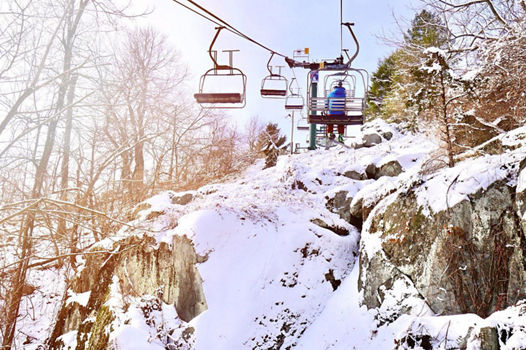 People Ride the Ramrod Triple Chairlift at Roundtop