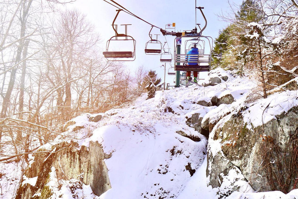 People Ride the Ramrod Triple Chairlift at Roundtop