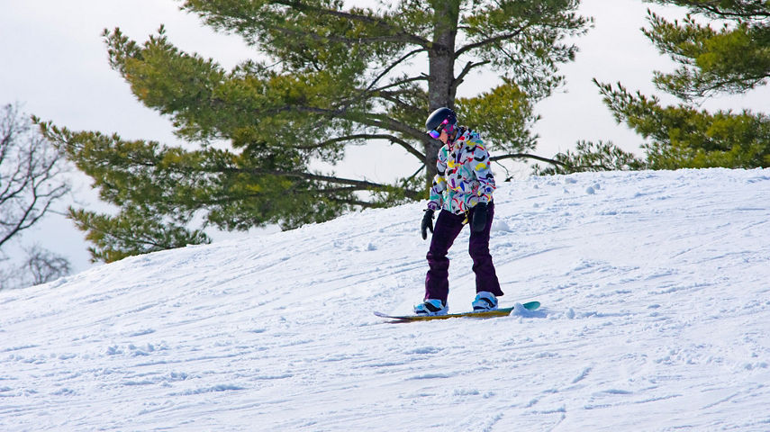 Woman Snowboards Downhill at Paoli Peaks