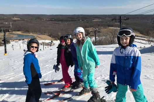 Group of Kids Poses on Skis at Hidden Valley