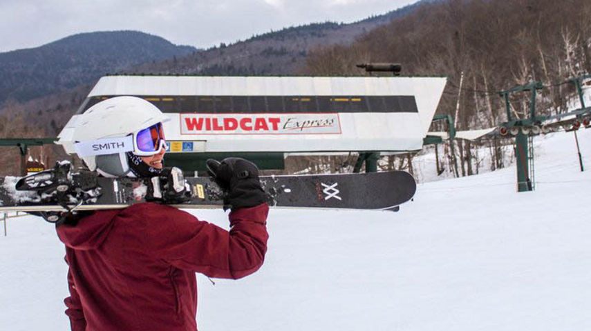 Woman Carries Skis to Wildcat Express Chairlift at Wildcat Mountain
