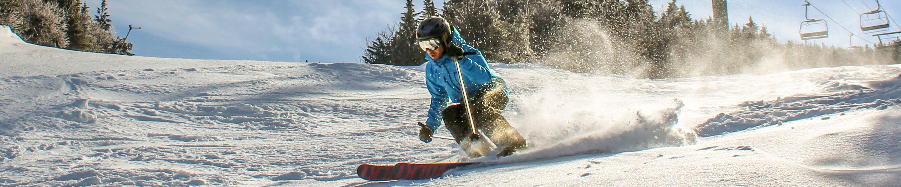 Skier Makes Quick Turns Under Chairlift at Wildcat Mountain