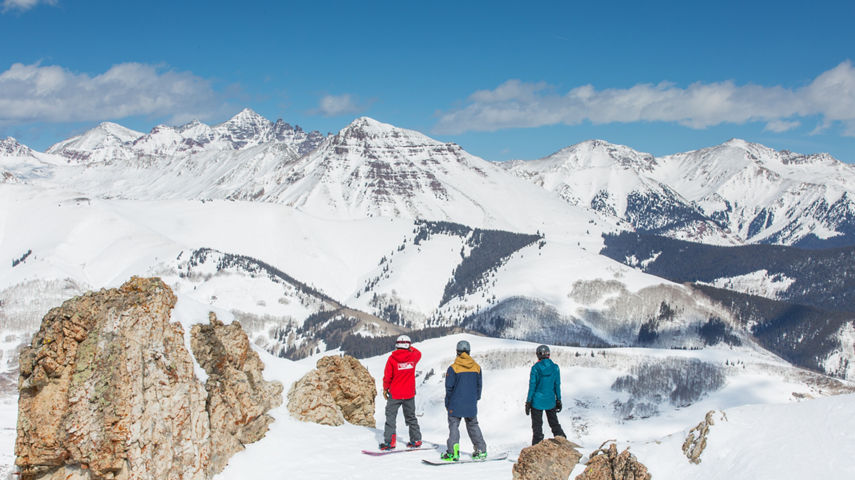 Ski & Ride School group of snowboarders looking out at Teocalli Mountain 