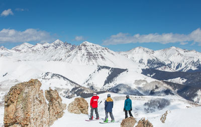 Ski & Ride School group of snowboarders looking out at Teocalli Mountain 