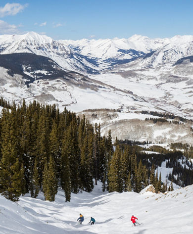 Ski & Ride School group of snowboarders riding down Halfpipe