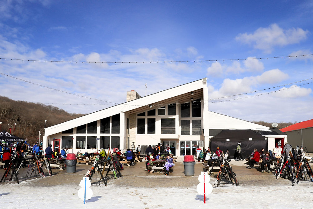 Guests enjoy a sunny day on the patio at Snow Creek