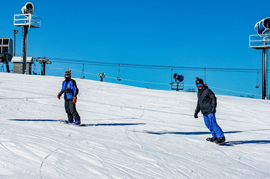 Two Friends Snowboarding Together at Paoli