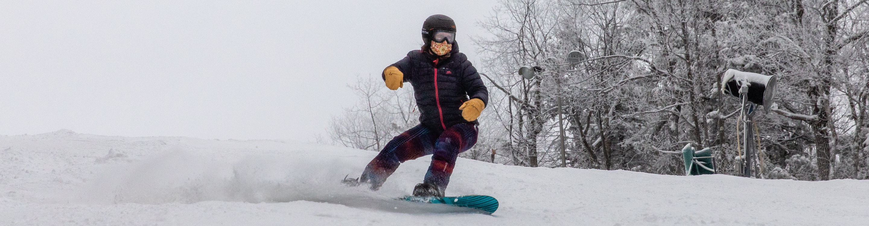 A snowboarder concentrates while at Crotched Mountain