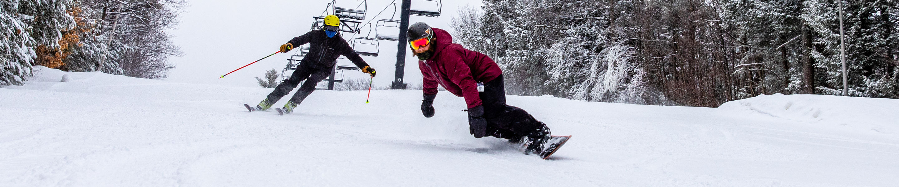 Skiing and riding under the chairlift at Crotched