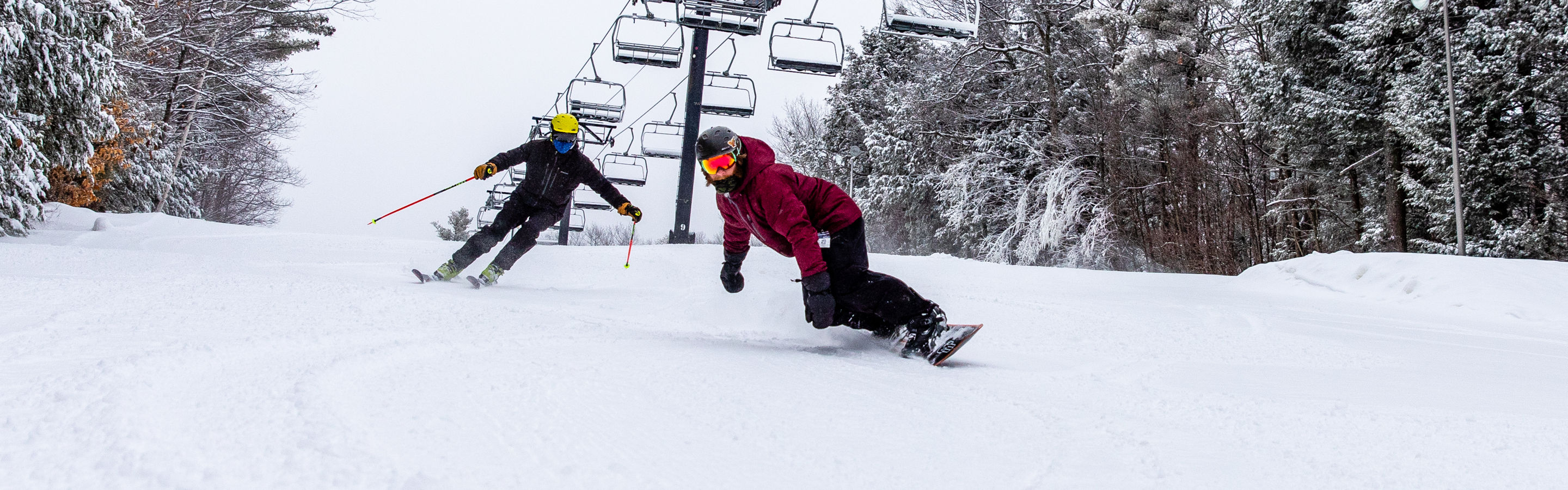 Skiing and riding under the chairlift at Crotched
