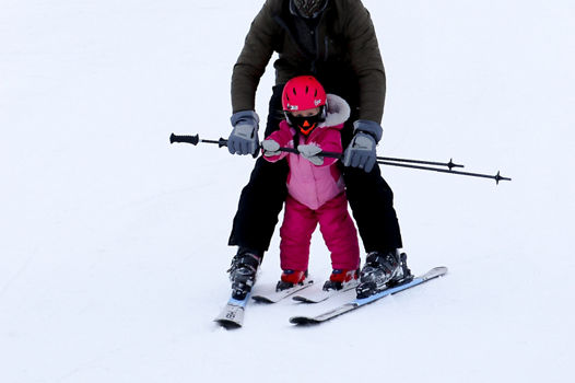 Father teaches daughter to ski at Snow Creek