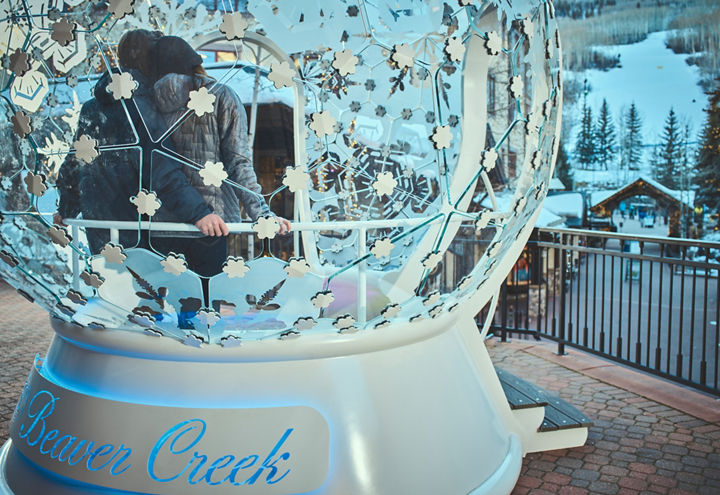 A couple relaxes inside of the Beaver Creek Snow Globe