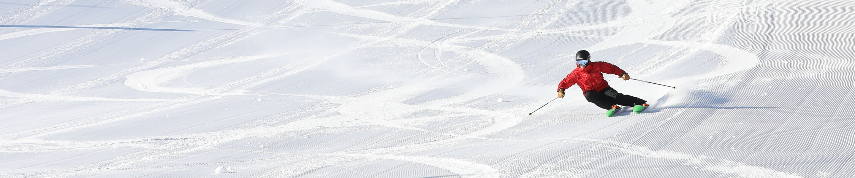 skier with fresh corduroy and tracks