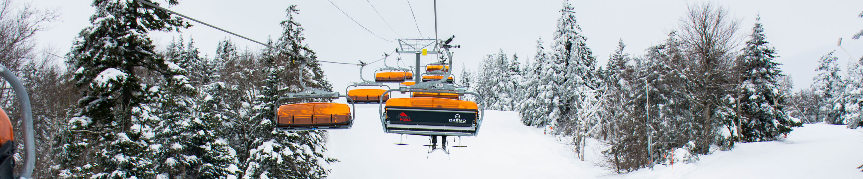 Snowboarding underneath the chairlift at Okemo