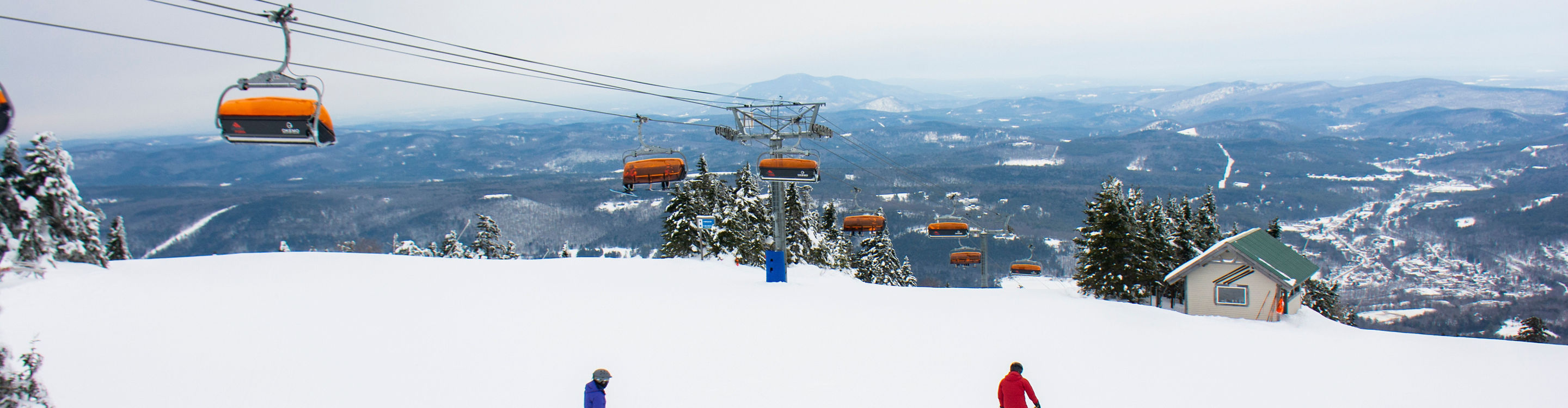 Guests ski under the chairlift at Okemo
