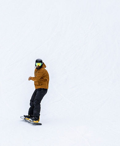Snowboarding carving down hill at Paoli