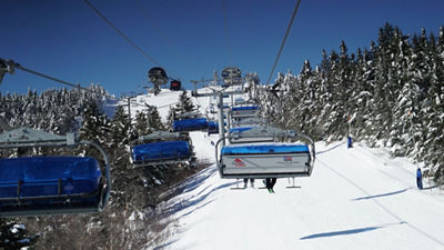 Bluebird Express over Lodge with Blue Skies and Snowy Trees at Mount Snow
