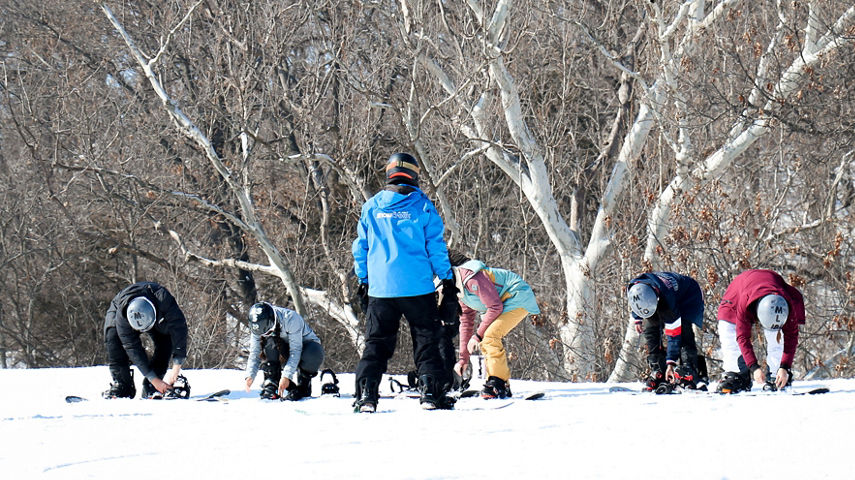 Guests participate in snowboard lessons at Snow Creek