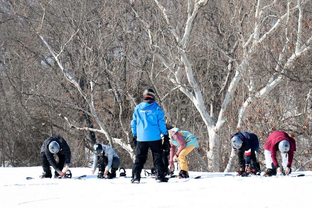 Guests participate in snowboard lessons at Snow Creek