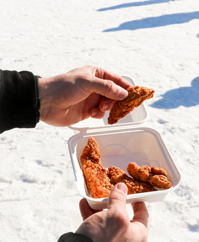 Customer holding chicken strips at Snow Creek