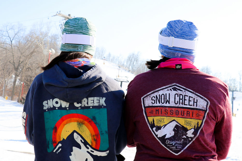 Friends show off their Snow Creek hoodies while hanging out at Snow Creek