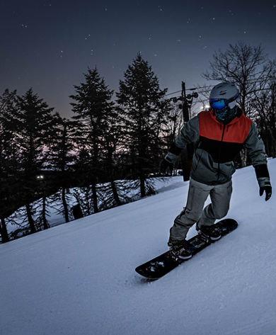 Adult Male Snowboarding at Night at Big Boulder