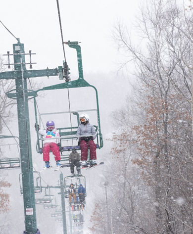 Guests on the Chairlift during a snowy day at Afton Alps, MN