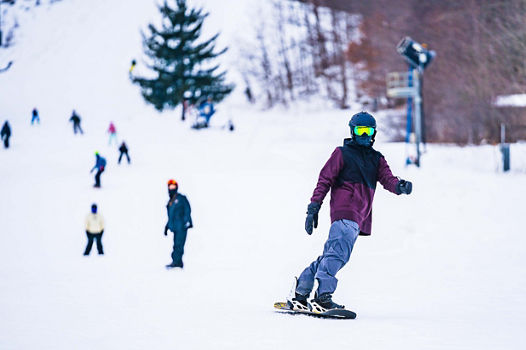 Snowboarders riding on New Years Eve Day at Alpine Valley