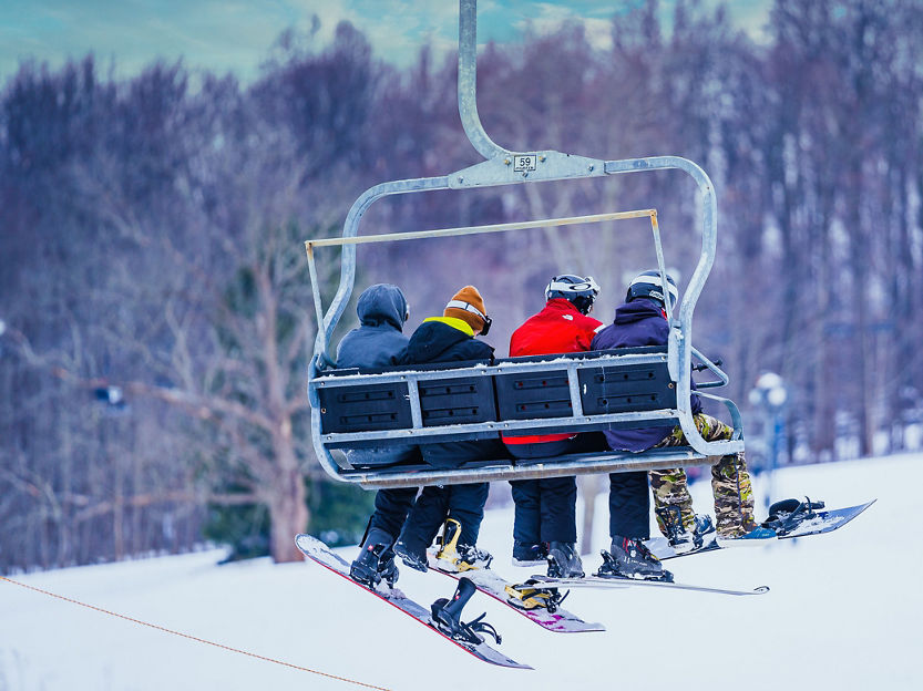 Friends on a chairlift during New Years Eve Day at Alpine Valley