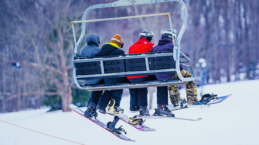 Friends on a chairlift during New Years Eve Day at Alpine Valley