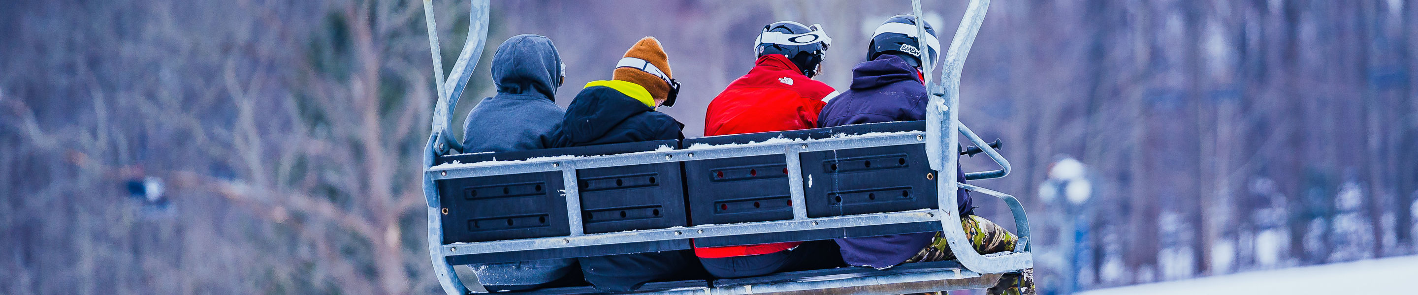 Friends on a chairlift during New Years Eve Day at Alpine Valley