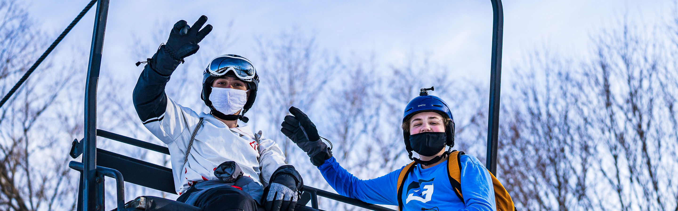 Guests wave from the chairlift at Alpine Valley