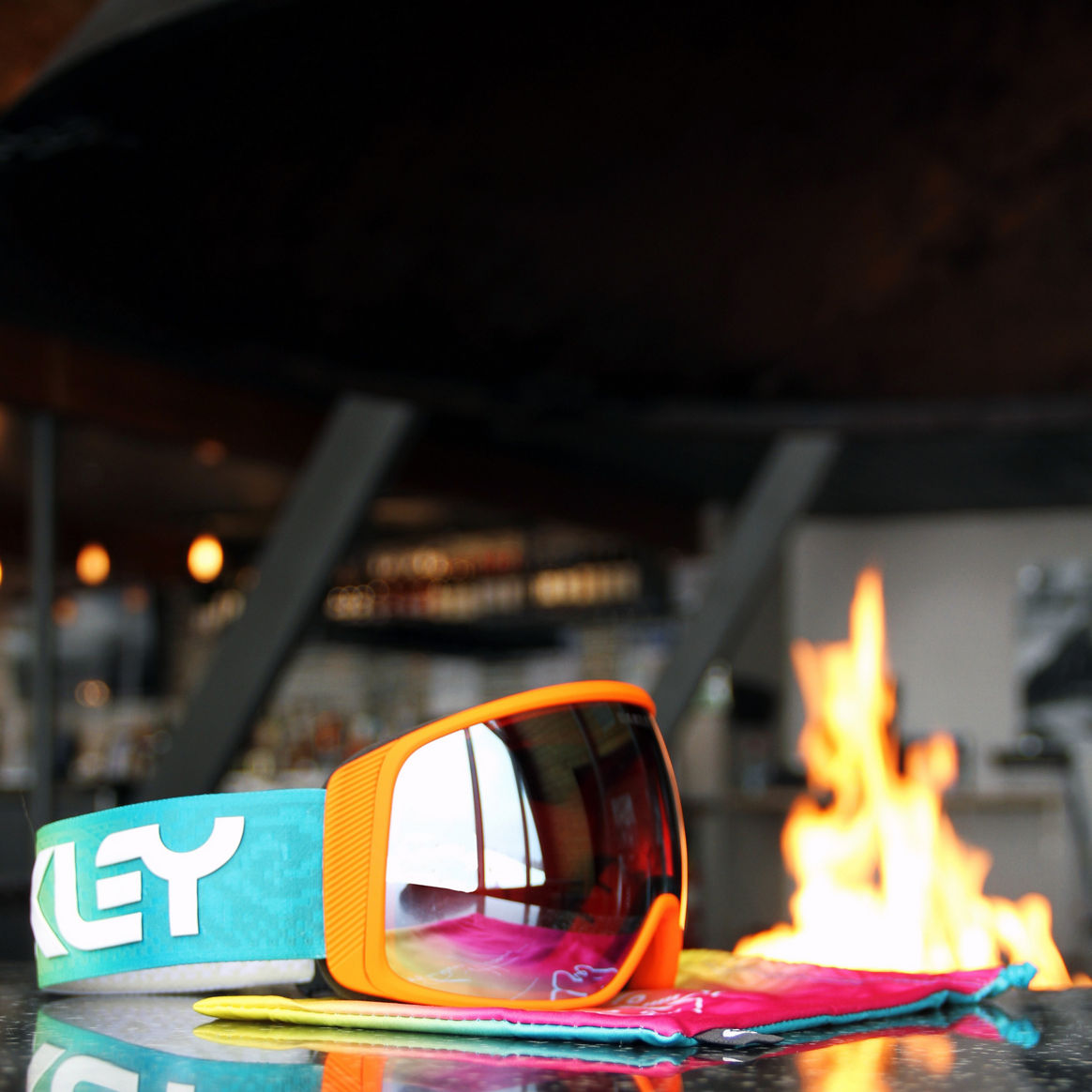 Ore Creek at Mt Brighton- Oakley Goggles on Table, Firepit Background