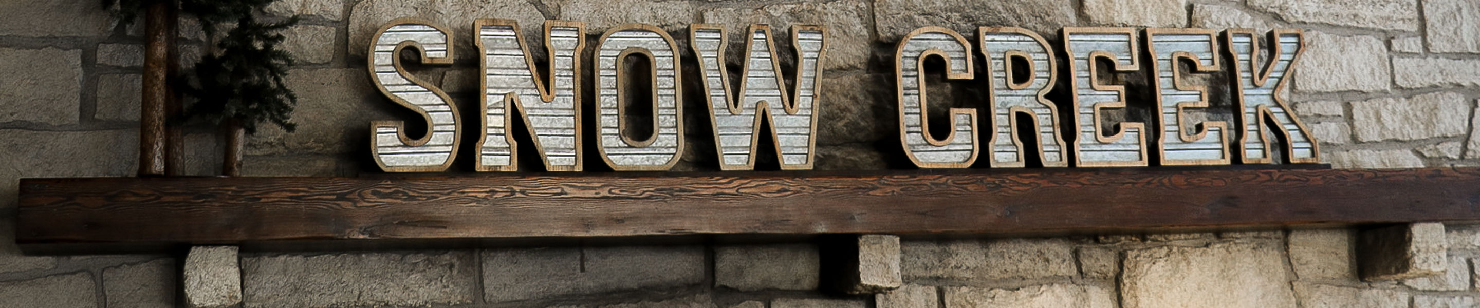 Snow Creek light sign above the fireplace mantel in the cafeteria at Snow Creek