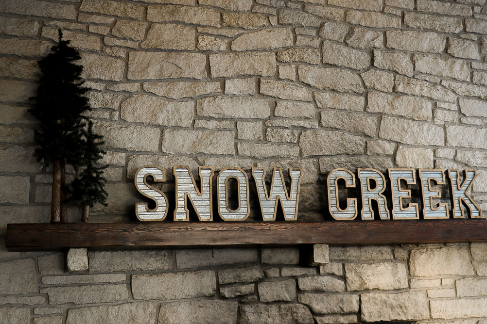 Snow Creek light sign above the fireplace mantel in the cafeteria at Snow Creek