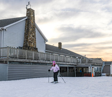 Girl Skiing away from Main Lodge to Slopes at Paoli Peaks
