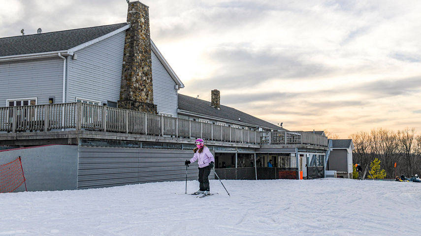 Girl Skiing away from Main Lodge to Slopes at Paoli Peaks