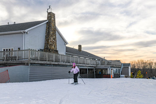 Girl Skiing away from Main Lodge to Slopes at Paoli Peaks