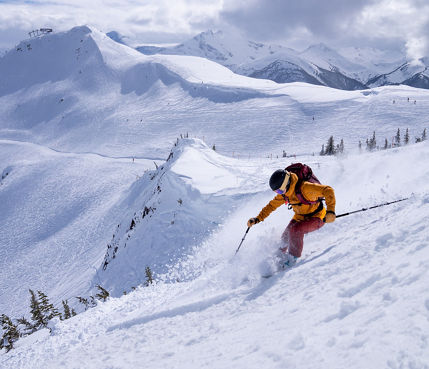 A woman skis the black diamond run - Sun Bowl at Whistler Mountain