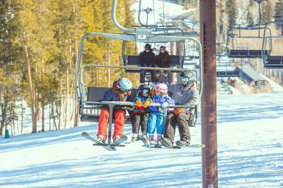 A family of skiers chat on the chairlift at Beaver Creek