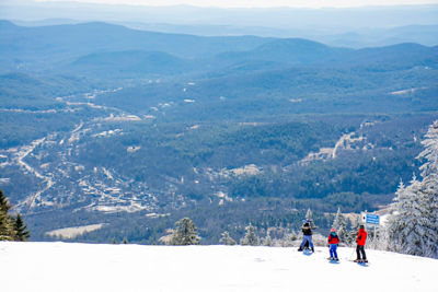 Guests ski at Okemo overlooking the view