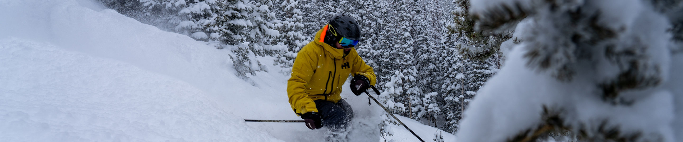 A skier in deep powder on a spring day at Breck