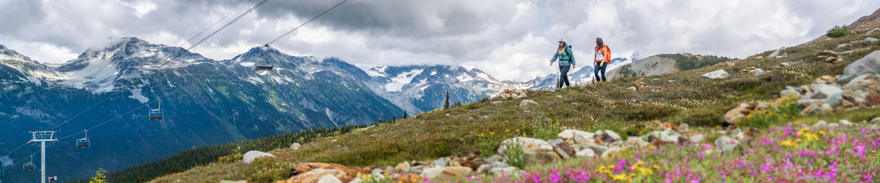 Backpackers Hike on Trail Beneath Chairlift at Whistler Blackcomb During Summer
