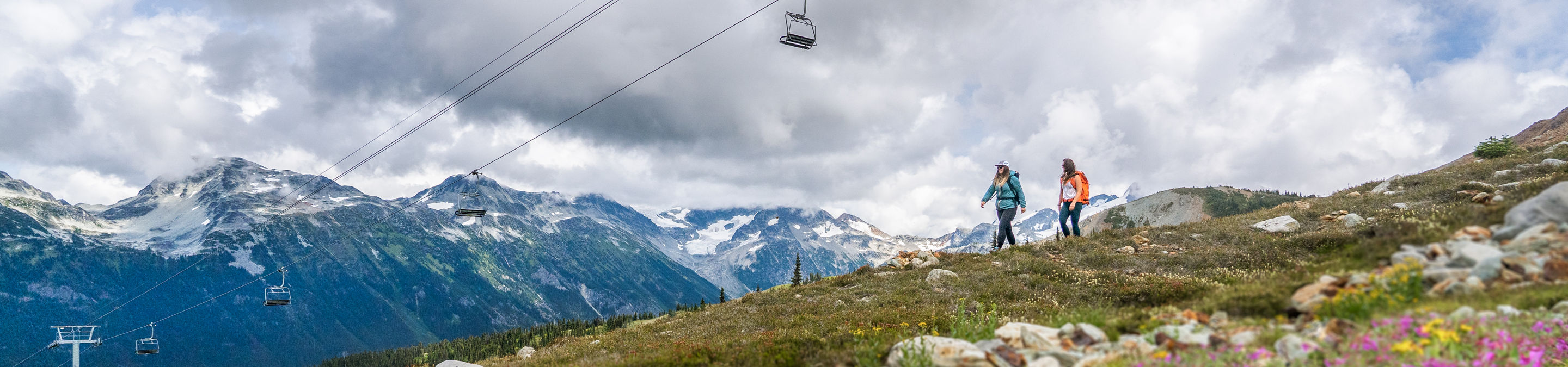 Backpackers Hike on Trail Beneath Chairlift at Whistler Blackcomb During Summer