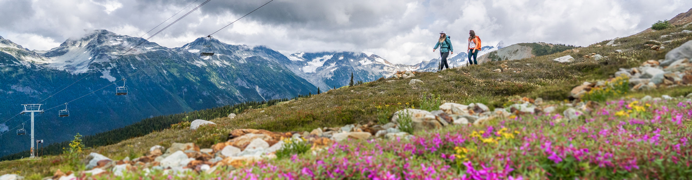 Backpackers Hike on Trail Beneath Chairlift at Whistler Blackcomb During Summer