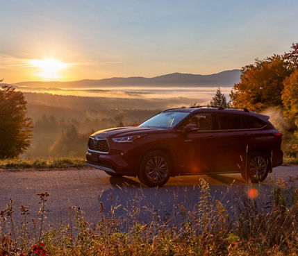 Toyota driving up Toll Road at Sunrise in Stowe